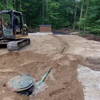 Complete septic system installation with excavator in Grey County Ontario